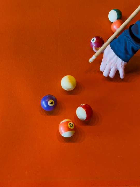 close up of an american pool table with pool balls