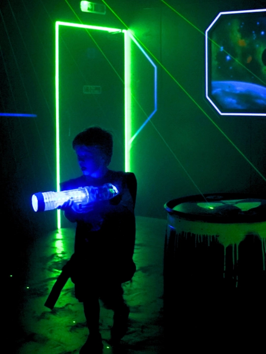 child playing laser quest at working superbowl